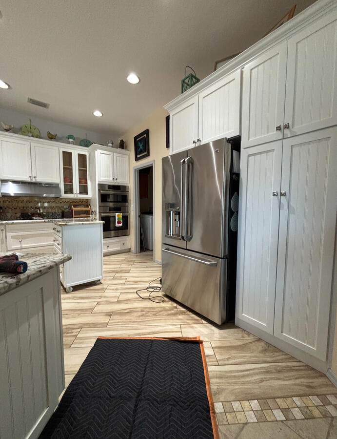 Before: Outdated White Cabinets, Dull Walls