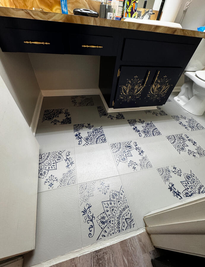 Custom black vanity with stenciled floor &amp; gold accent
