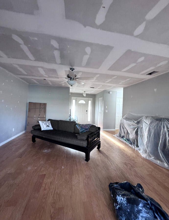 Unfinished drywall ceiling and unpainted walls